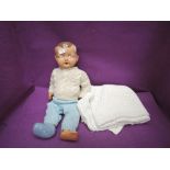 A English style 1950's composition doll having painted eyes, open mouth and jointed body, wearing