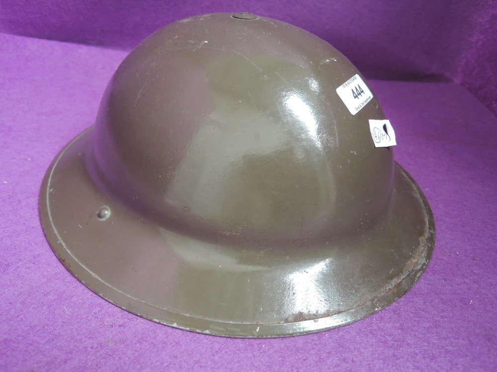 A World War II British military helmet, stamped on inside R.O.Co DM 1939