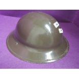 A World War II British military helmet, stamped on inside R.O.Co DM 1939