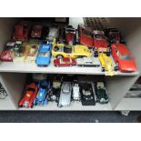 Two shelves of Maisto, Burago and similar 1:18 and similar scale diecasts including Jaguars,