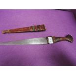 A Nigerian dagger with leather handle and decorated leather scabbard