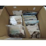 A collection of vintage postcards in box including real photographs of street scenes