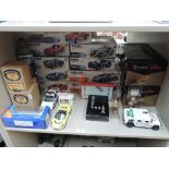 A shelf of mixed diecasts and toys including nine Burago 1:24 & 1:18 scale kit cars, all made up and