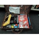 A vintage suitcase containing various electronic games including Blip, Logic 5, AmazeATron etc