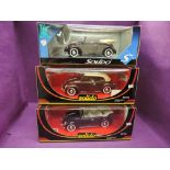 Three Solido Prestige 1:18 scale diecast VW Coccinelle cars in various shades of brown, all in