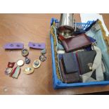 A collection of Masonic items including book, aprons, medals on ribbons, set squares, medals, badges