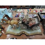 A Capo Di Monte Model, with figures in a horse drawn carriage, signed B Merli, on gilt base and