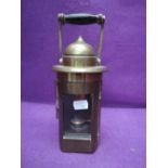 A brass Piper Montreal hanging oil lamp having clear glass window and wood handle