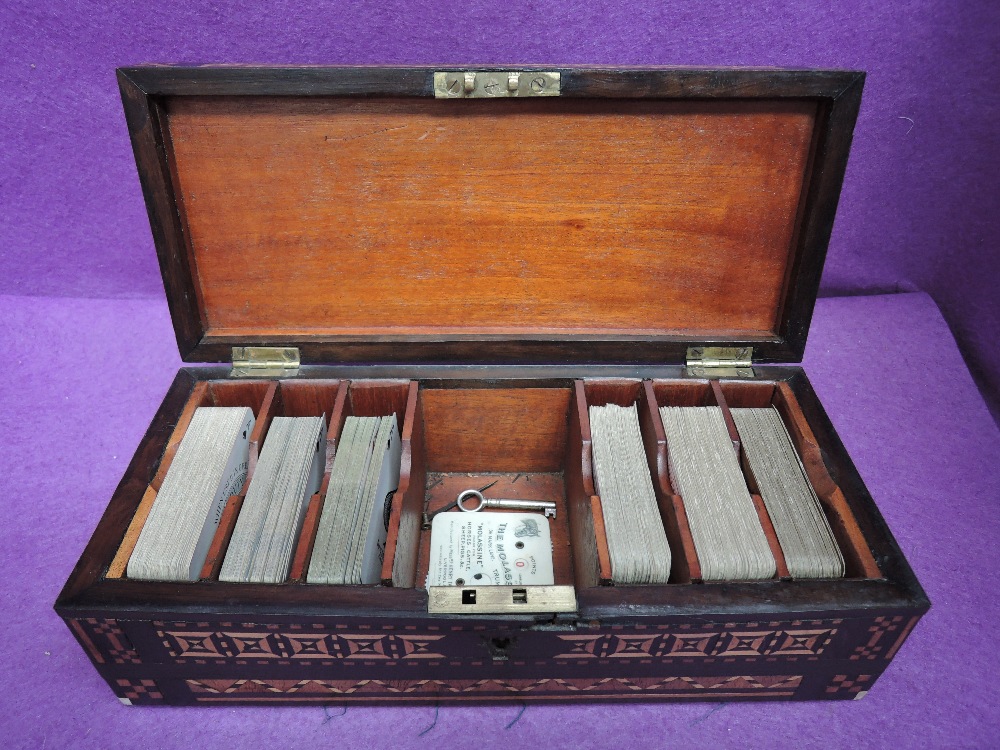 A 19th century mahogany and marquetry rectangular playing card box containing six decks of Goodall