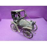 A hand made metal model vintage car, made out of hinges, springs. Bolts and similar spare parts