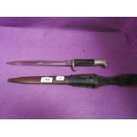 A German dress bayonet, metal scabbard and leather frog, good condition, made by E Pack & Sohne