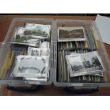 A large collection of vintage postcards in two plastic boxes, several hundred