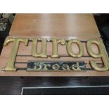 A large hand made advertising sign to Turog bread hand cut and raised letters with hand painted
