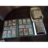 A collection of cigarette cards in two boxes, and an album including silks, Junior Member No10