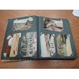 A large vintage postcard album containing comic, real photograph cards