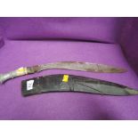 A large kukri knife with bone and metal handle and scabbard