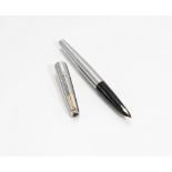 A Parker fountain pen. A Parker 61 fountain pen in brushed metal and gold trim