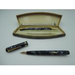 A boxed Conway Stewart 388 fountain pen and pencil set, in Blue Marble, medium nib, lever fill, good