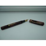 An Underwood fountain pen, Burgundy marble, medium nib, lever fill, good condition, made in the USA