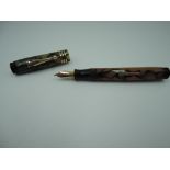 A Gold Bond fountain pen, circa 1921, Black and Pearl stonite, lever fill