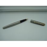 A Parker fountain pen, brushed steel with gold trim, good condition, made in the UK