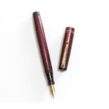 A Mabie Todd Swan fountain pen. A leverless Mabie Todd Swan fountain pen in garnet lizard skin