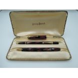 A boxed Conway Stewart 17 pen and pencil set, circa 1950, red and black candle flame, medium nib,