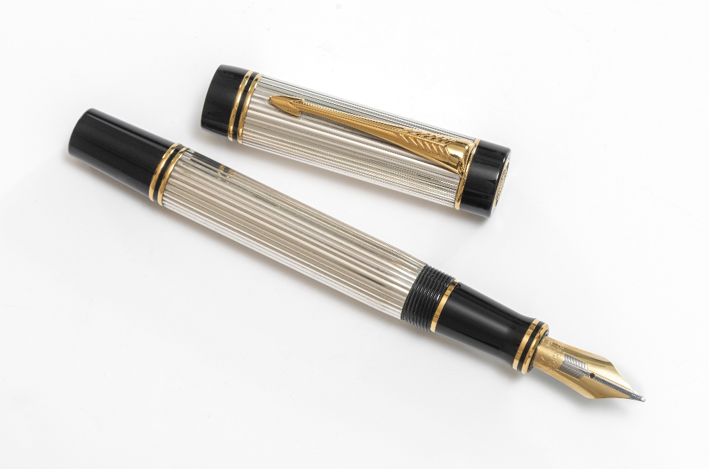A Parker fountain. A Parker Duofold Centennial fountain pen with silver reeded body, gold clip and