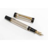 A Parker fountain. A Parker Duofold Centennial fountain pen with silver reeded body, gold clip and