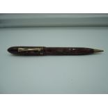 A National Security fountain pen and propelling pencil combo, circa 1928, red and Black ripple,