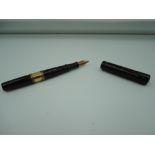 A Waterman Ideal 12 1/2 fountain pen, circa 1900, Black Chased Hard Rubber with Gold band, clipless,