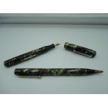 A Wahl Oxford fountain pen and pencil set, Green and Brown marble, lever fill, requires attention,