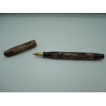 An Epenco fountain pen, Brown marble, medium nib, lever fill, fair condition, made in the USA