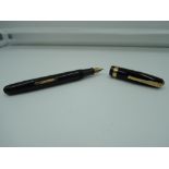 A boxed Waterman 515 fountain pen, Black with Gold trim, medium nib, lever fill good condition, made