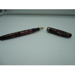 A Parker Challenger fountain pen, circa 1930, Red marble, single cap band, fine nib, button fill,