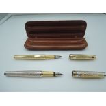 Two boxed Cross fountain pens, one gold, one silver with gold trim, cartridge, made in China
