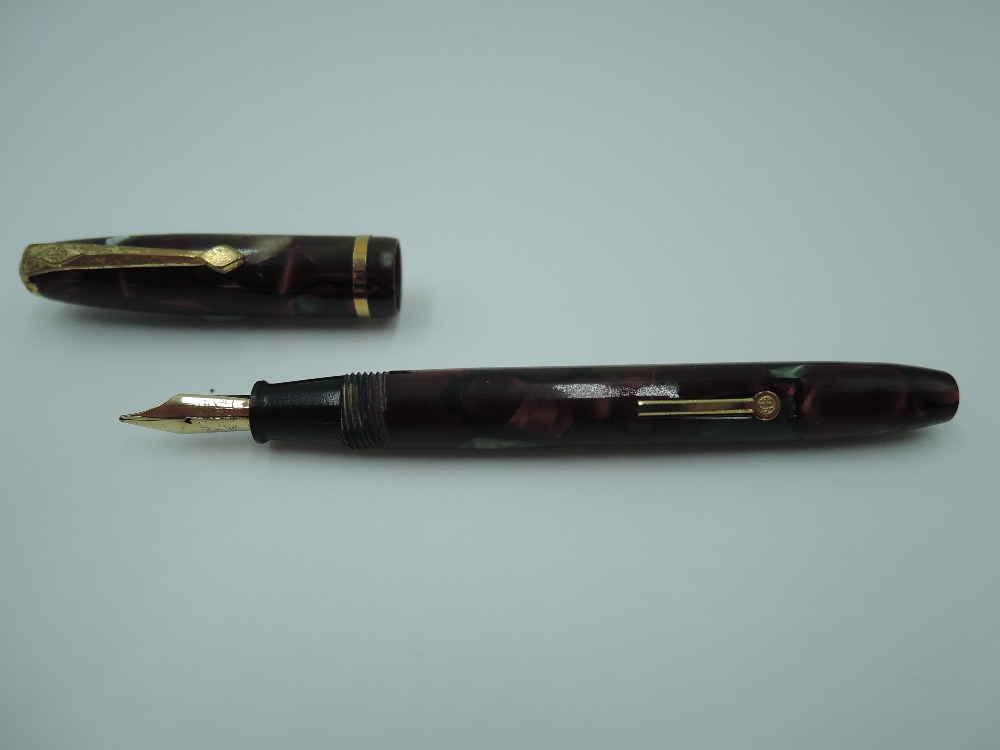 A Conway Stewart Dinkie 550 fountain pen, circa 1950, in plum, burgundy, green marble, medium nib,
