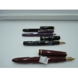 Four fountain pens. A Parker Duofold, a Parker Vacumatic made in Canada, a Mabie Todd Leverless