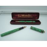 A boxed Mabie Todd fountain pen and pencil set, circa 1928, Green marble, medium nib, lever fill,