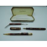 A Conway Stewart 769M boxed pen and pencil set with pen knife, circa 1924, red and black mottled,