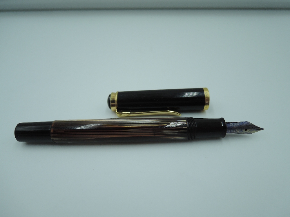 A Pelikan fountain pen, with a black and gold striped effect body, in leather case