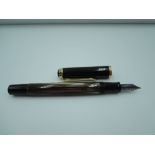A Pelikan fountain pen, with a black and gold striped effect body, in leather case
