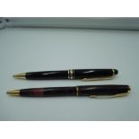 Two ballpoint pens, a Montblanc Meisterstuck in black and a Parker Sonnet in black and red in soft