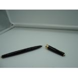 A Parker 45 fountain pen, circa 1967, Black with gold trim, medium nib, converter, fair condition