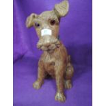 A wooden carved dog figure like Airedale of terrier