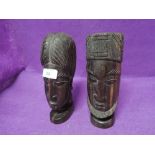 A pair of African heads carved from heavy ethnic hard woods