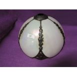 A tiffany style light shade with mother of pearl style body