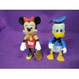 Two Walt Disney figures marked made in Hong Kong