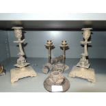 A selection of candle sticks including brass cast and mythical sea creature