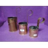 A selection of brass and copper graduated measures
